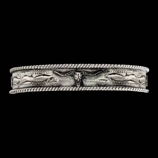 "Elevate your western style with our Keith Western Cuff Bracelet. Crafted on a hand-engraved German Silver base and featuring our signature antique finish, this cuff showcases a traditional rope-edge design. At its center is a figure, complemented by